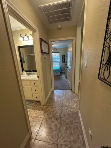 a view of a hallway and a livingroom with furniture