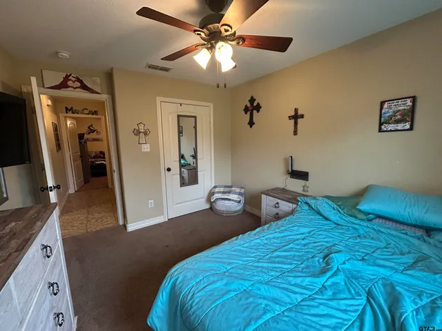 a bedroom with bed and a chandelier