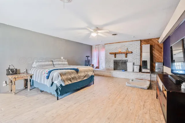 a bedroom with a large bed and a chandelier