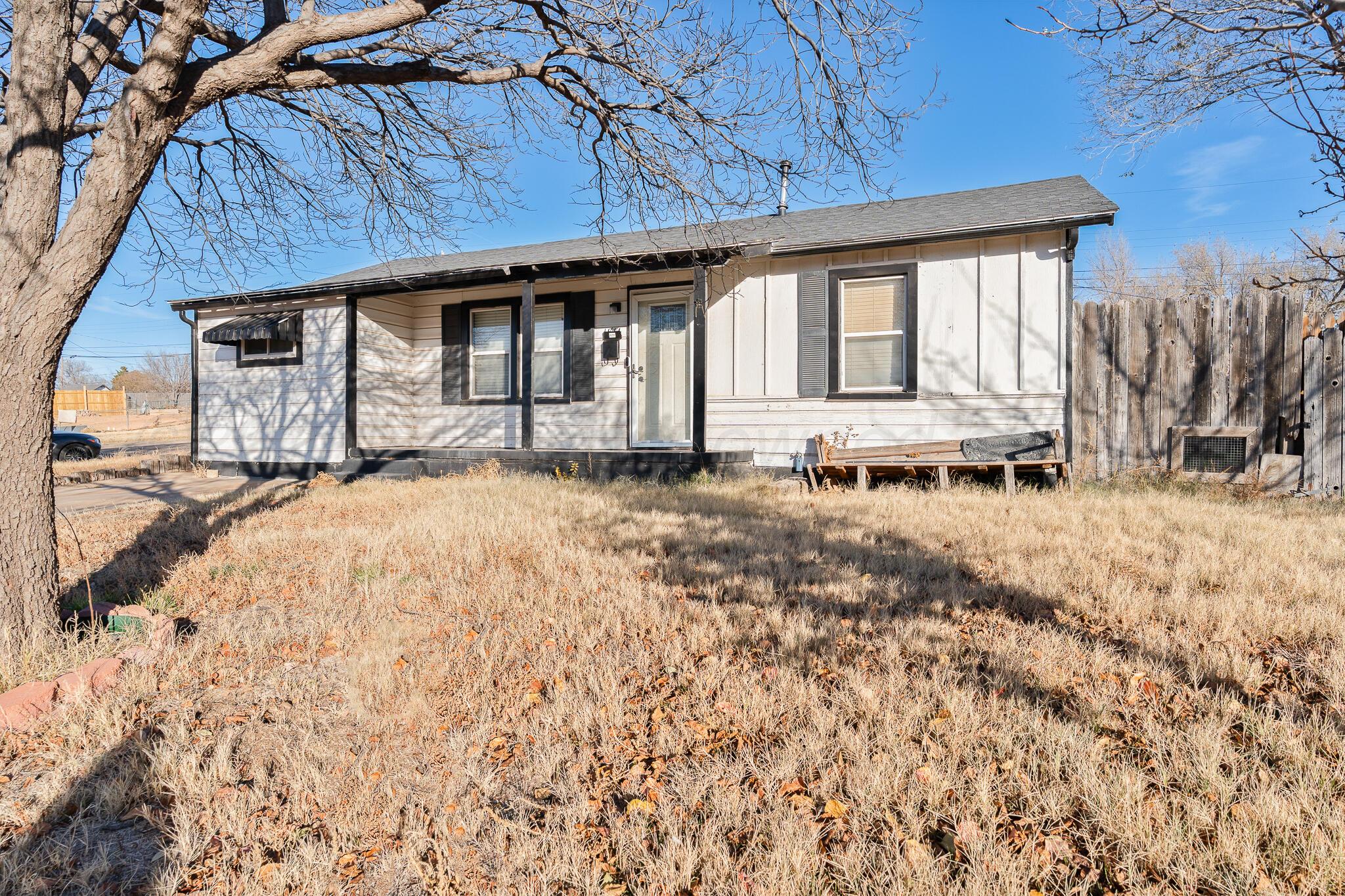 1814 Magnolia Street Amarillo, TX 79107 - Photo 4 of 26 a view of a house with a yard covered in snow