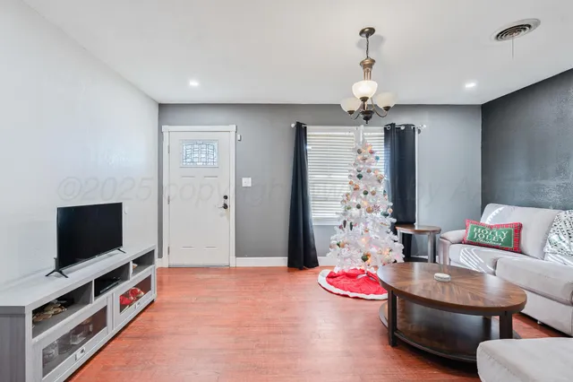 a living room with furniture and a flat screen tv