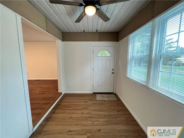 a view of empty room with wooden floor