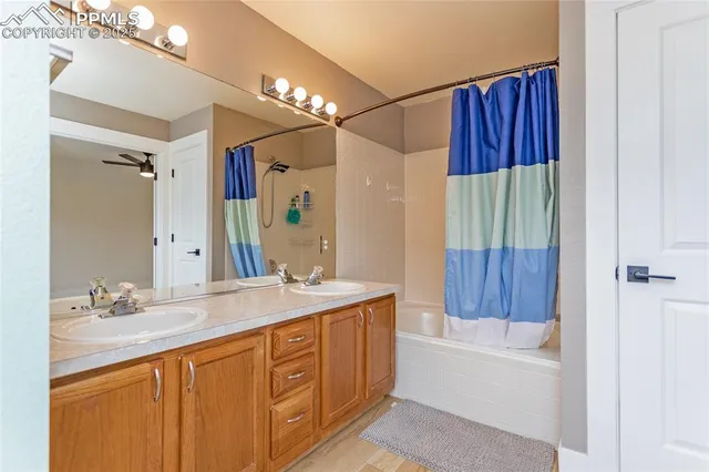 a bathroom with a tub a sink and a large mirror