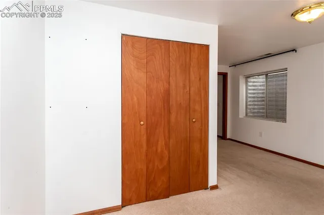 a view of an empty room with windows