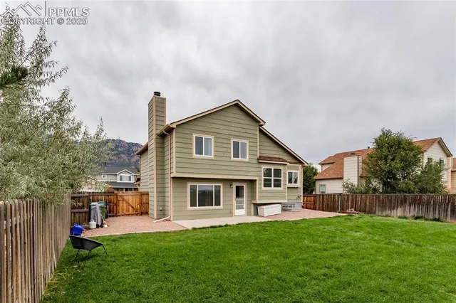 a front view of a house with a garden and yard