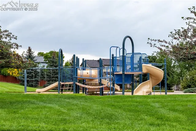 a view of a house with backyard and a slide