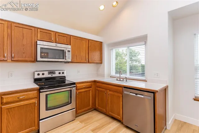 a kitchen with sink a microwave and cabinets