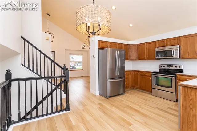 a kitchen with stainless steel appliances a refrigerator and a stove top oven