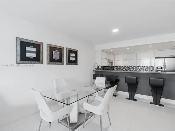 a view of a dining room with furniture and a potted plant