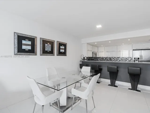 a view of a dining room with furniture and a potted plant