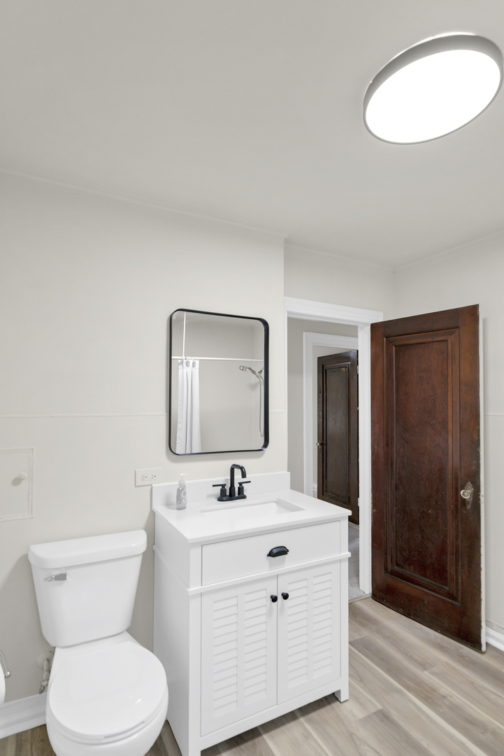 624 Lincoln Avenue Elgin, IL 60120 - Photo 15 of 24 a bathroom with a toilet sink and mirror