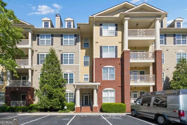 a front view of a residential apartment building with a yard