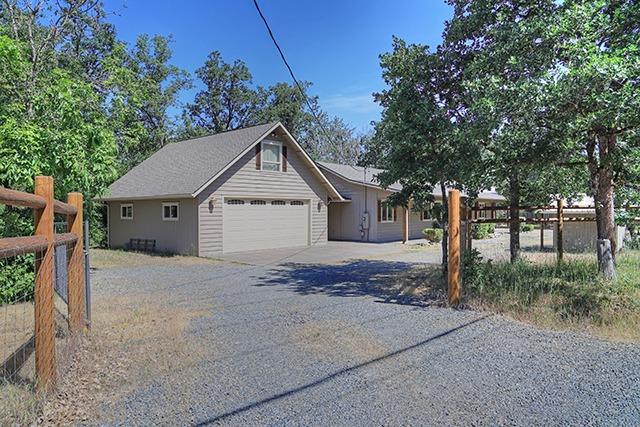 1502 Pleasant Valley Road Merlin, OR 97532 - Photo 1 of 23 a view of a house with a yard and large tree