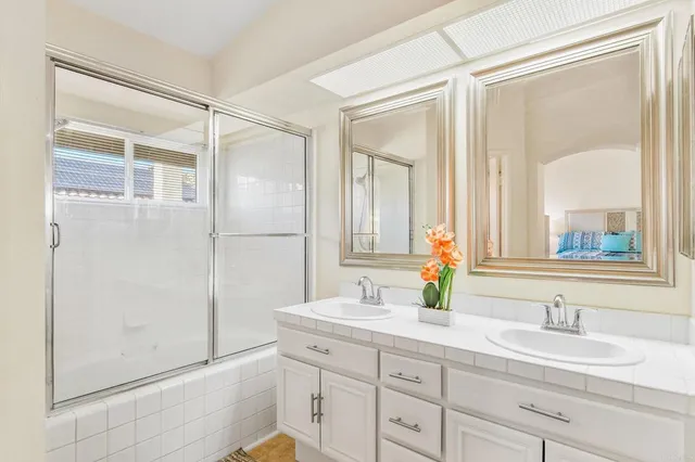 a bathroom with a double vanity sink and a mirror