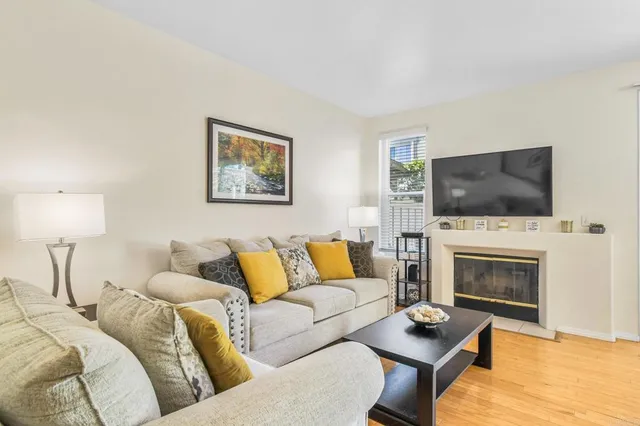 a living room with furniture flat screen tv and a fireplace