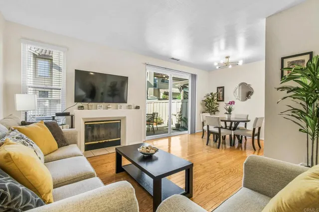 a living room with furniture a fireplace and a flat screen tv