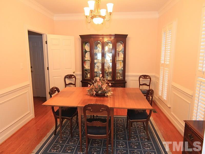 2937 Sunnystone Way Raleigh, NC 27613 - Photo 8 of 25 a view of a dining room with furniture window and wooden floor