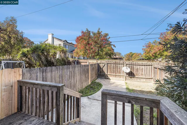 a view of house with backyard and sitting area