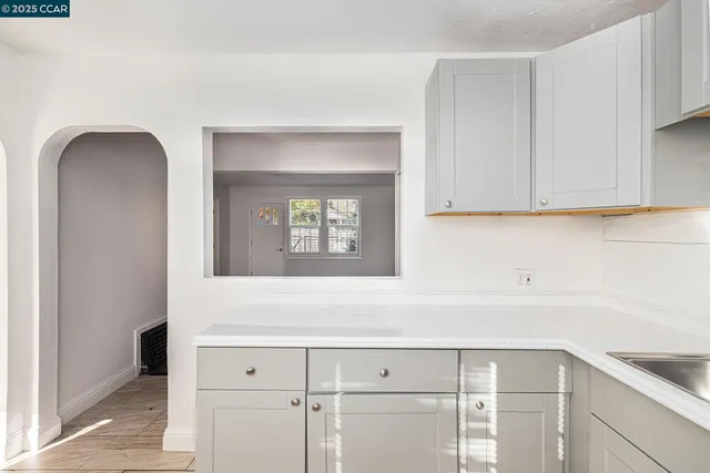 a view of a kitchen with refrigerator and cabinet
