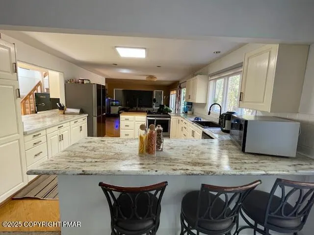 a bedroom with a bed and a wall painting