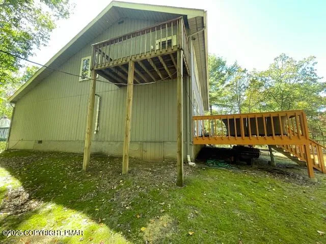 a view of a livingroom with furniture and staircase