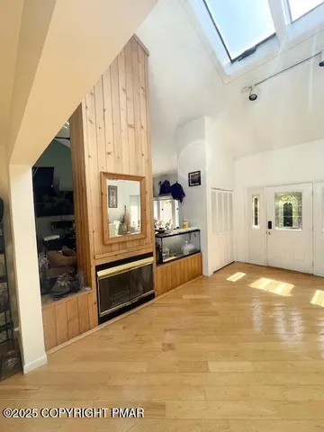 a kitchen with granite countertop white cabinets appliances a sink and a large window