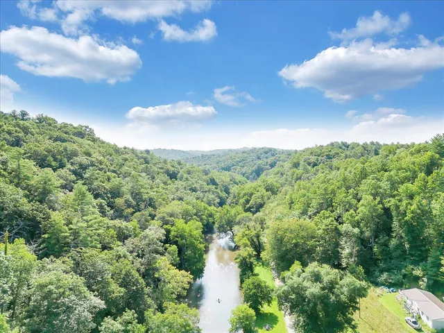 a view of a lake with houses in the background