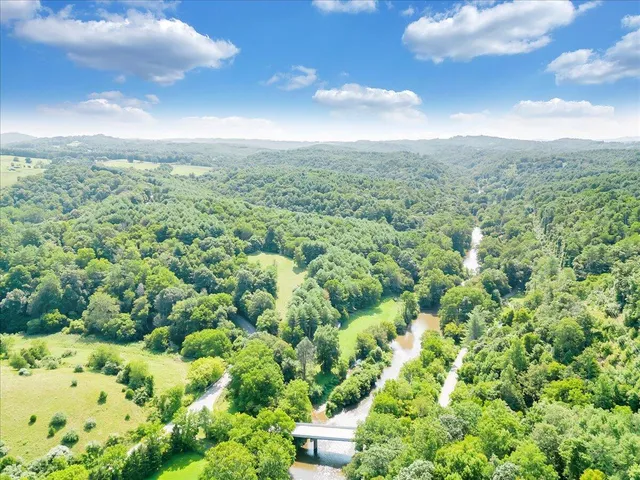 an aerial view of a houses with yard