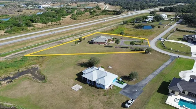 an aerial view of a house with a outdoor space swimming pool
