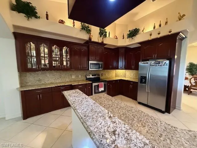 a kitchen with stainless steel appliances granite countertop a sink and a stove