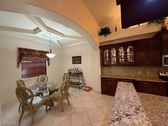 a kitchen with stainless steel appliances granite countertop a sink a stove and a refrigerator