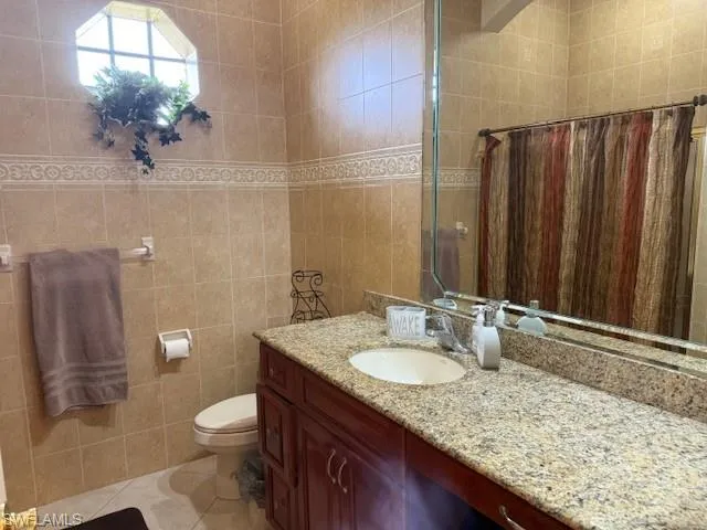 a bedroom with a bed and a ceiling fan