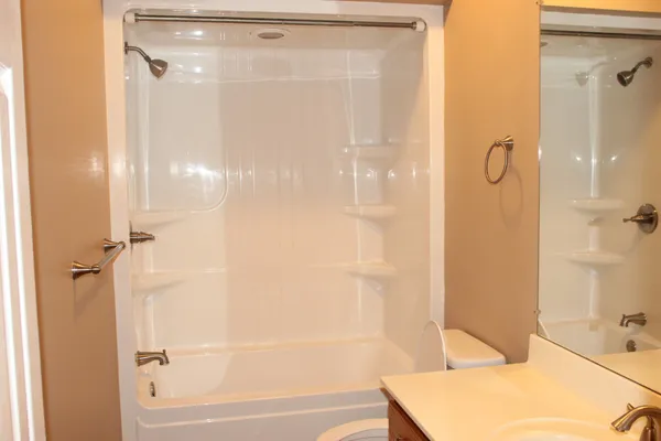 a bathroom with a bathtub and a shower