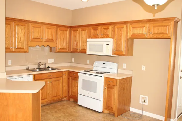 a kitchen with a stove a sink and a refrigerator