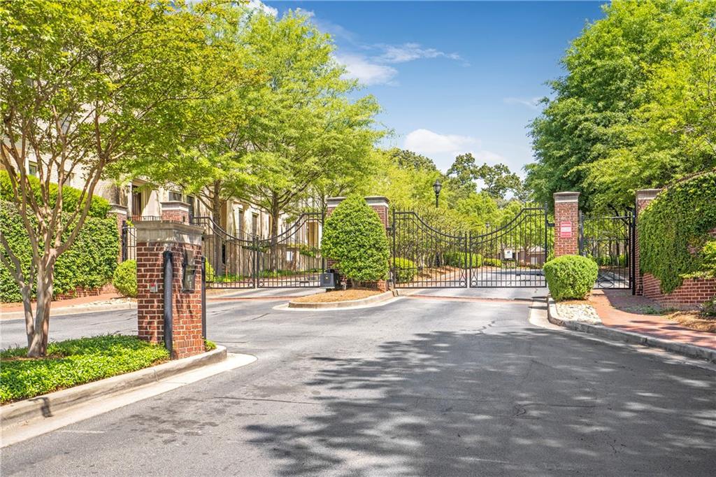 3635 East Paces Circle, Unit 1109 Atlanta, GA 30326 - Photo 2 of 22 a view of a street with trees on both side of it