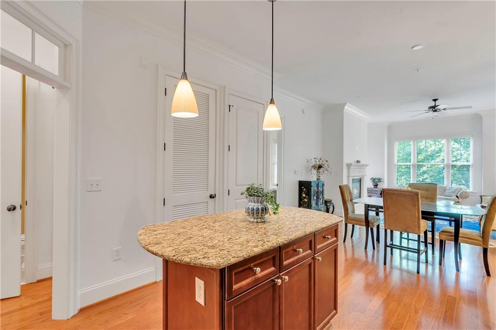 3635 East Paces Circle, Unit 1109 Atlanta, GA 30326 - Photo 10 of 22 a kitchen with a table chairs and wooden floor