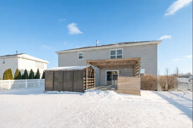 a view of a house with a snow in the background