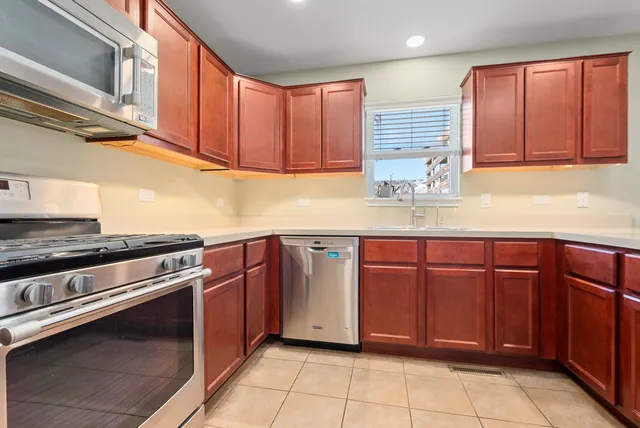a kitchen with stainless steel appliances granite countertop a sink and cabinets