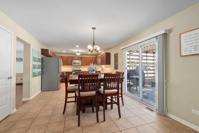 a view of a dining room with furniture and chandelier