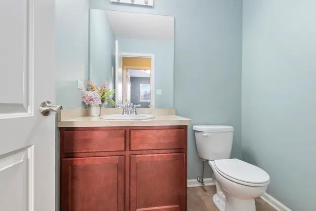 a bathroom with a toilet sink and mirror