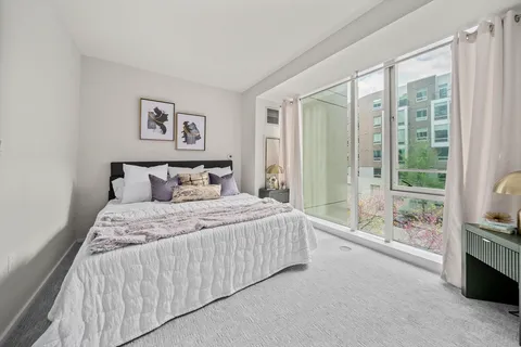 a bedroom with a large bed and a window