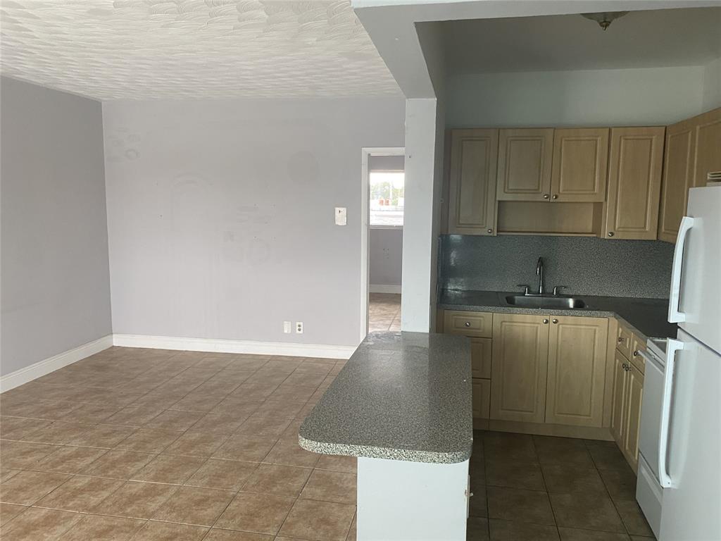 800 Northeast 13th Street, Unit 6 Fort Lauderdale, FL 33304 - Photo 12 of 13 a kitchen with a sink and cabinets