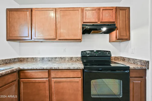a kitchen with granite countertop cabinets sink and a granite counter top