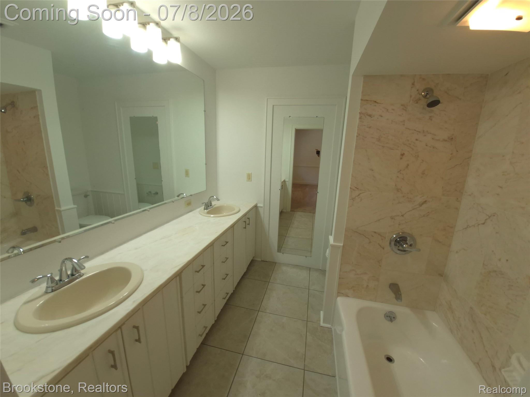 4140 South Henderson Road Davison, MI 48423 - Photo 66 of 98 Bathroom featuring a full-width vanity with dual sinks, extensive under-counter storage, and a large wall-mounted mirror
