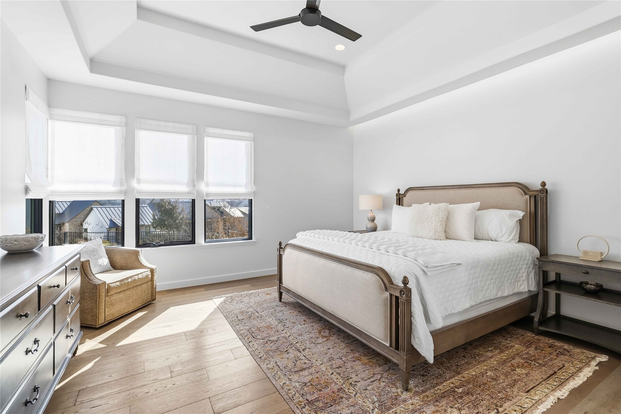 410 Kayak Way Austin, TX 78738 - Photo 17 of 40 a bedroom with a bed couch and a large window