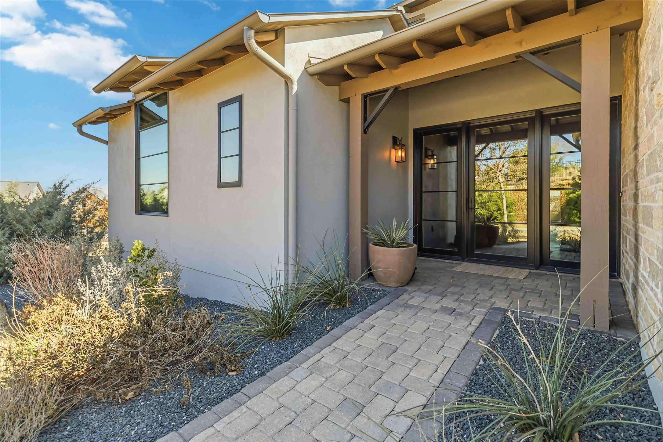 410 Kayak Way Austin, TX 78738 - Photo 5 of 40 a view of a house with potted plants next to a road