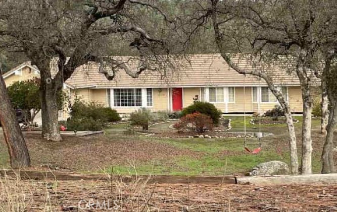 28899 Limestone Way Coarsegold, CA 93614 - Photo 1 of 3 a front view of a house with garden