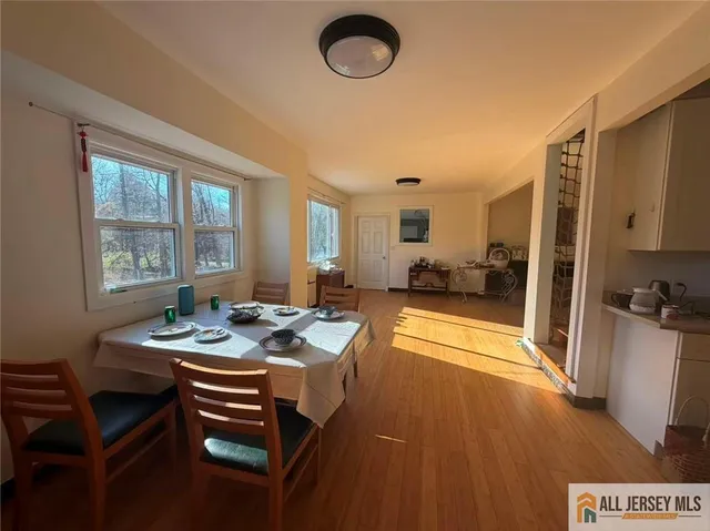 a dining room with furniture and a floor to ceiling window