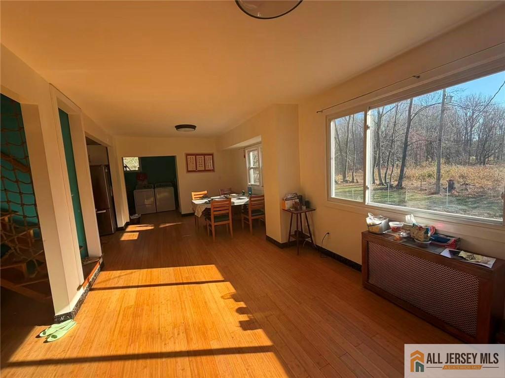 57 North Disbrow Hill Road Monroe Township, NJ 08831 - Photo 9 of 24 a living room with a large window wooden floor and furniture