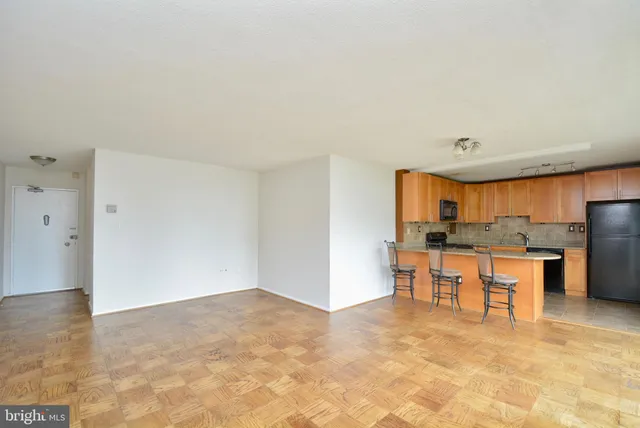 a view of kitchen with furniture and refrigerator